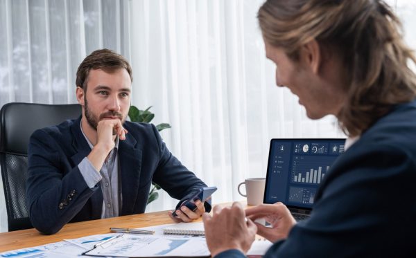 Busy analyst team in office analyzing financial data analysis for marketing strategy in workspace using BI dashboard with graph and chart on laptop screen to improve business performance. Entity