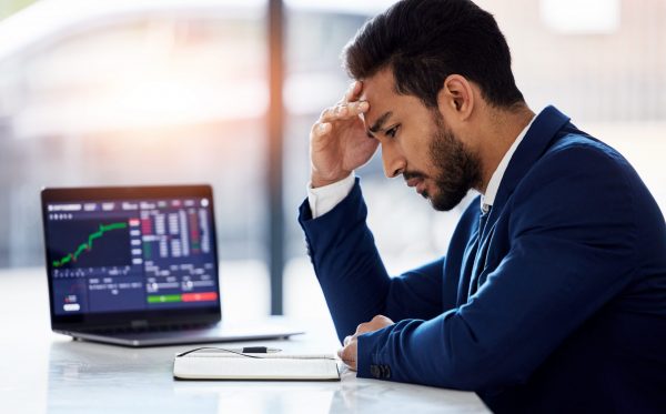Trading, sad and laptop with man and stock market crash for finance, inflation and investment. Failure, anxiety and stress with male employee for accounting risk, data analytics and trade crisis.