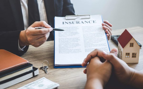 Estate agent broker reach contract form to client signing agreement contract real estate with approved mortgage application form, buying or concerning mortgage loan offer for and house insurance.